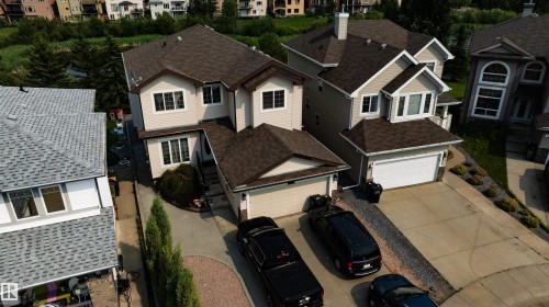 Two-story residential property with light-colored siding and a dark shingle roof - 715 Wildwood Point(E) Nw, Edmonton, AB - Outdoor With Facade