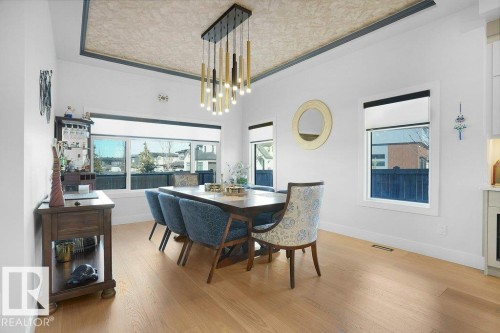 5104 Woolsey Link Nw, Edmonton, AB - Indoor Photo Showing Dining Room With Fireplace