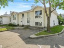 White siding exterior with multiple prominent windows - #2 3311 58 St Nw, Edmonton, AB  - Outdoor 