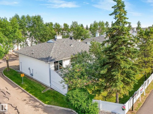 Exterior featuring white siding, a gray shingle roof, and a skylight - #2 3311 58 St Nw, Edmonton, AB - Outdoor