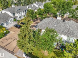 Exterior residential property featuring white siding and gray shingle roofing - 