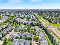 Aerial perspective showcasing the residential community with established landscaping and mature trees - 