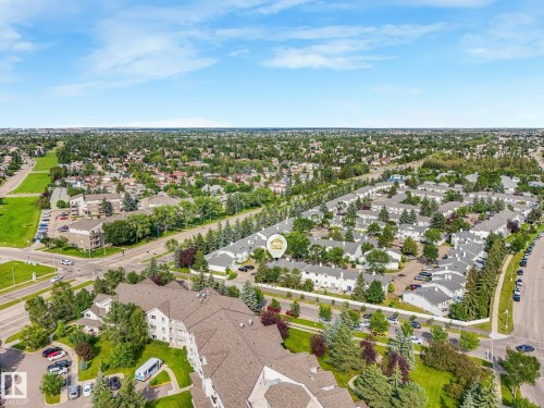 Expansive aerial perspective showcasing a residential community with abundant mature trees and verdant green spaces - #2 3311 58 St Nw, Edmonton, AB - Outdoor With View
