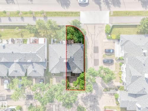 Aerial property overview featuring a shingled roofline, established trees, and a defined property boundary - #2 3311 58 St Nw, Edmonton, AB - 