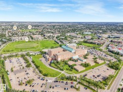 Aerial perspective showcasing a large-scale institutional building with extensive parking facilities - 