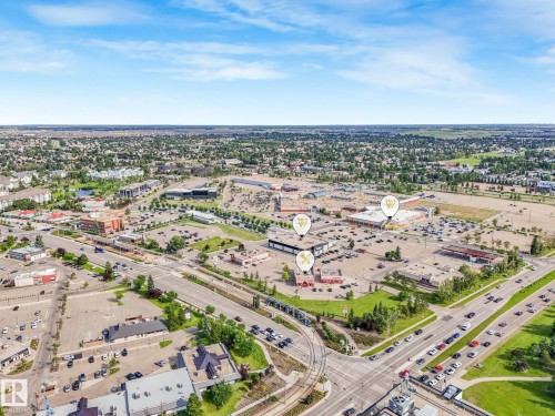 Aerial perspective showcasing a commercial development with multiple buildings and expansive parking areas - #2 3311 58 St Nw, Edmonton, AB - Outdoor With View
