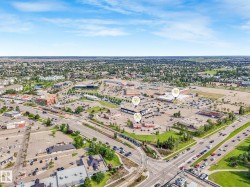 Aerial perspective showcasing a commercial development with multiple buildings and expansive parking areas - 