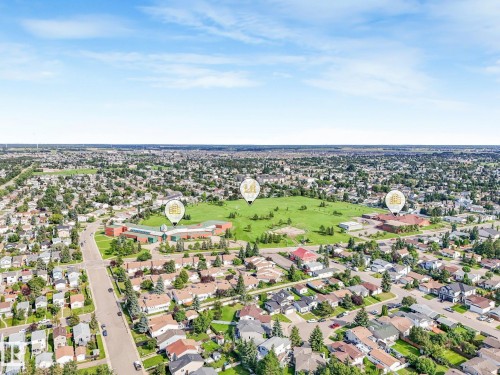 Aerial perspective showcasing a residential area with a prominent green space - #2 3311 58 St Nw, Edmonton, AB - Outdoor With View