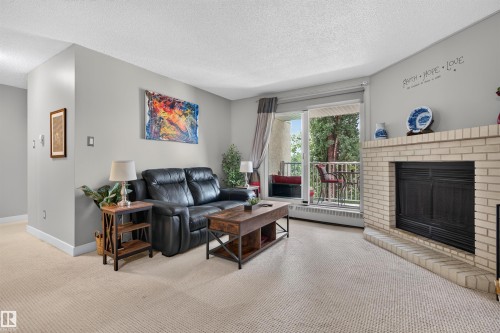 #302 11020 19 Av Nw, Edmonton, AB - Indoor Photo Showing Living Room With Fireplace