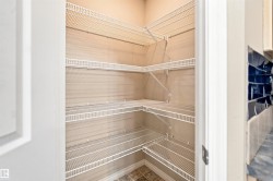 Pantry featuring multiple levels of wire shelving, corner shelving, and tile flooring - 