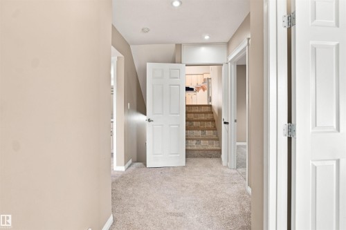 Hallway featuring light beige carpeting and recessed lighting - 1328 80 Street Sw, Edmonton, AB - Indoor Photo Showing Other Room