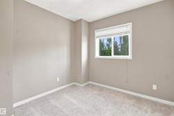 Interior room featuring neutral wall tones and a window with horizontal blinds - 