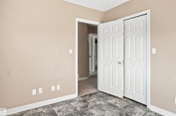 Room featuring grey patterned flooring, neutral wall tones, and white trim - 