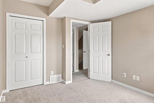 Neutral tone walls with white trim and multi-panel interior doors - 1328 80 Street Sw, Edmonton, AB - Indoor