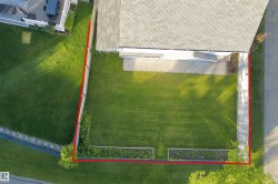 Expansive green lawn with established fence line - 