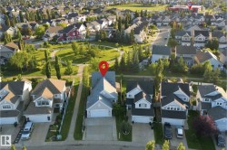 Suburban neighborhood featuring varied architectural styles and mature trees - 