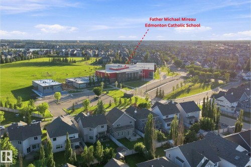 Aerial view of a residential community featuring numerous single-family homes with gray roofs and varied siding - 1328 80 Street Sw, Edmonton, AB - Outdoor With View