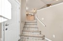 Entryway featuring tile-finish stairs and neutral wall tones - 1328 80 Street Sw, Edmonton, AB  - Indoor Photo Showing Other Room 