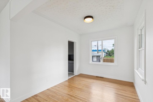 Room featuring wood-finish flooring and bright white walls - 8202 93A Avenue Nw, Edmonton, AB - Indoor Photo Showing Other Room