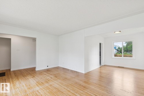 Bright interior space featuring light wood-finish flooring - 8202 93A Avenue Nw, Edmonton, AB - Indoor