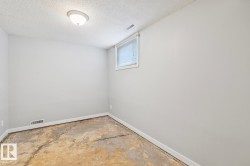 Room featuring light gray walls, a textured ceiling, and a flush-mount ceiling light fixture - 