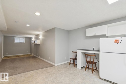 Lower-level living space featuring recessed lighting and a built-in counter - 8202 93A Avenue Nw, Edmonton, AB - Indoor