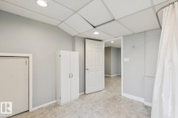 Utility space featuring tile flooring, neutral wall paint, and recessed lighting - 