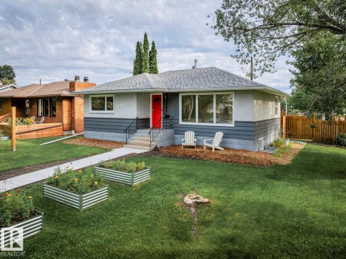 Single-story residence featuring a gray and white exterior with a vibrant red entry door - 8202 93A Avenue Nw, Edmonton, AB - Outdoor
