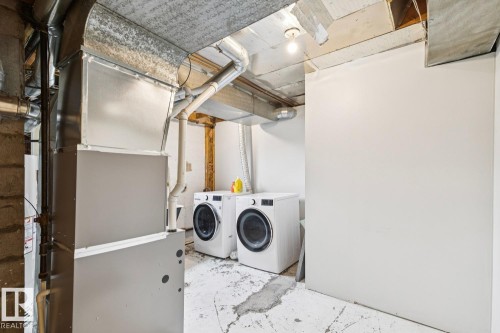 Utility area with exposed ductwork, concrete flooring, and an open ceiling - 8202 93A Avenue Nw, Edmonton, AB - Indoor Photo Showing Laundry Room