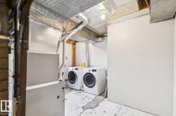 Utility area with exposed ductwork, concrete flooring, and an open ceiling - 