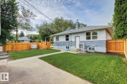Rear exterior featuring light grey stucco and horizontal siding - 
