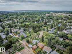 Aerial perspective of a tree-lined residential area with multiple single-family residences - 
