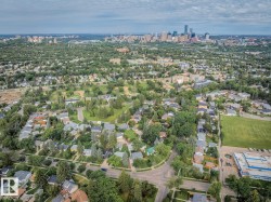 Expansive aerial perspective showcasing a residential neighborhood with a distant cityscape - 
