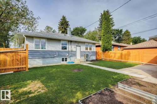Expansive backyard featuring a concrete patio, walkway, and driveway - 8202 93A Avenue Nw, Edmonton, AB - Outdoor