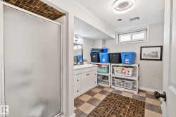 Frosted glass shower enclosure featuring mosaic tile surround - 