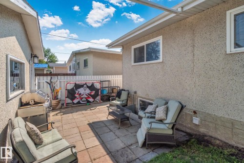 Paved patio area featuring block pavers and a white privacy fence - 4723 105 Street Nw, Edmonton, AB - Outdoor With Deck Patio Veranda With Exterior