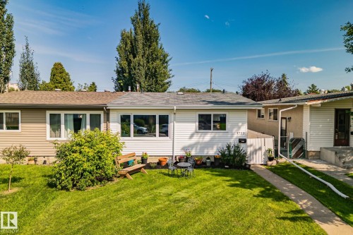 Front exterior featuring white horizontal siding, a gray shingle roof, and a neatly maintained lawn - 4723 105 Street Nw, Edmonton, AB - Outdoor