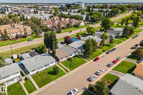 Aerial perspective of a residential neighborhood featuring detached homes with shingle roofs and manicured lawns - 4723 105 Street Nw, Edmonton, AB - Outdoor With View