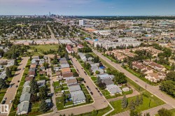 Aerial perspective showcasing a residential neighborhood with diverse housing styles, including detached homes and multi-family complexes - 