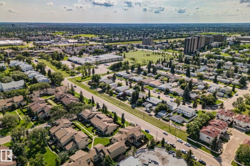Aerial perspective showcasing a residential area featuring single-family homes and multi-story buildings - 4723 105 Street Nw, Edmonton, AB - Outdoor With View