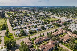 Expansive suburban neighborhood featuring a variety of residential properties, mature trees, and paved roadways - 