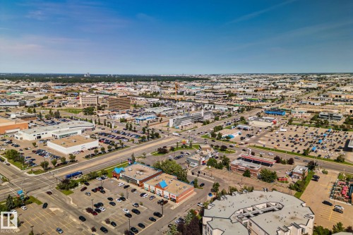 Expansive aerial perspective showcasing a commercial district with multiple retail establishments, surface parking areas, and a network of roadways - 4723 105 Street Nw, Edmonton, AB - Outdoor With View
