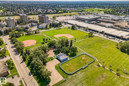 Expansive parkland featuring multiple baseball diamonds, a multi-sport court, walking paths, and mature trees - 4723 105 Street Nw, Edmonton, AB - Outdoor With View