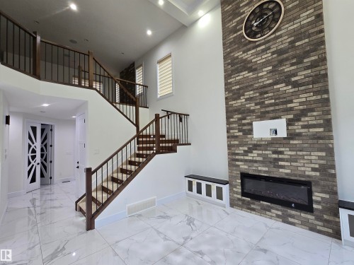 228 36 Street Sw, Edmonton, AB - Indoor Photo Showing Other Room With Fireplace