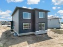Modern two-story residence featuring dark grey horizontal siding and white-framed windows - 423 Robinson Bv, Leduc, AB  - Outdoor With Exterior 