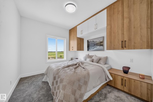 Integrated wood-finish cabinetry and overhead storage define this bedroom space - 423 Robinson Bv, Leduc, AB - Indoor Photo Showing Bedroom