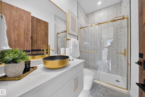 Bathroom featuring a gold vessel sink, white countertop, and light gray cabinetry with gold hardware - 423 Robinson Bv, Leduc, AB - Indoor Photo Showing Other Room