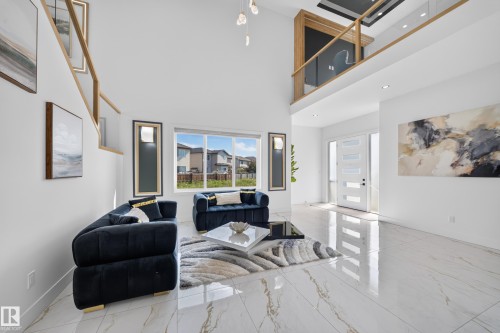 Two-story living area with high ceilings, large windows, and an open-concept design - 423 Robinson Bv, Leduc, AB - Indoor