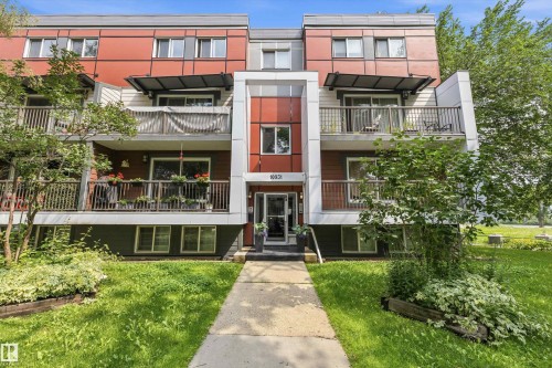 Modern multi-story building featuring a red and gray facade with white accents - #8 10931 83 St Nw, Edmonton, AB - Outdoor With Balcony With Facade