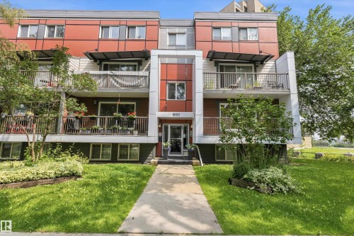 Multi-level residential building featuring a prominent central entrance and individual balconies - #8 10931 83 St Nw, Edmonton, AB - Outdoor With Balcony With Facade
